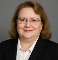 Woman with glasses and somewhat curly hair